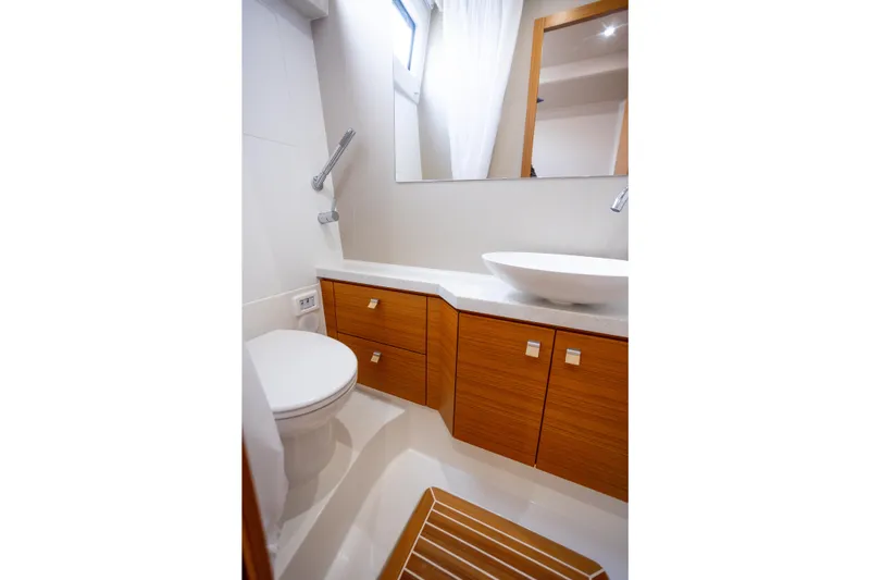 Tui Yacht Photos Pics Modern bathroom in 2023 Greenline 48 Fly yacht with wooden cabinetry and sleek fixtures.
