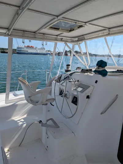  Yacht Photos Pics Helm of 2000 Manta 42 catamaran with ocean view in background.