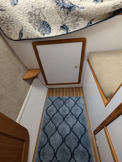  Yacht Photos Pics Interior of 2000 Manta 42 boat with blue patterned rug and wooden accents.