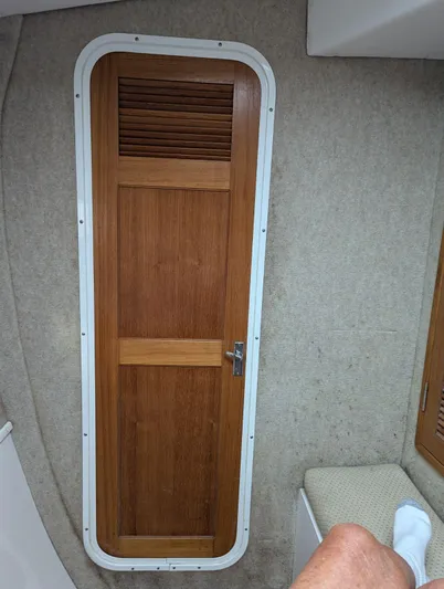  Yacht Photos Pics Wooden door inside a 2000 Manta 42 boat cabin, featuring a vented panel.