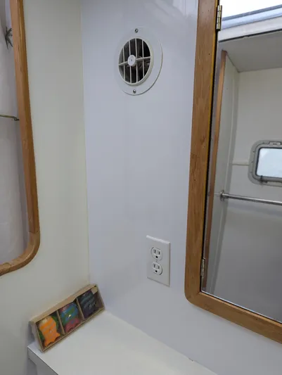  Yacht Photos Pics Interior of a 2000 Manta 42 boat, featuring a bathroom with a vent and mirror.