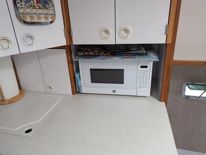  Yacht Photos Pics Compact kitchen area in a 2000 Manta 42, featuring a built-in microwave.