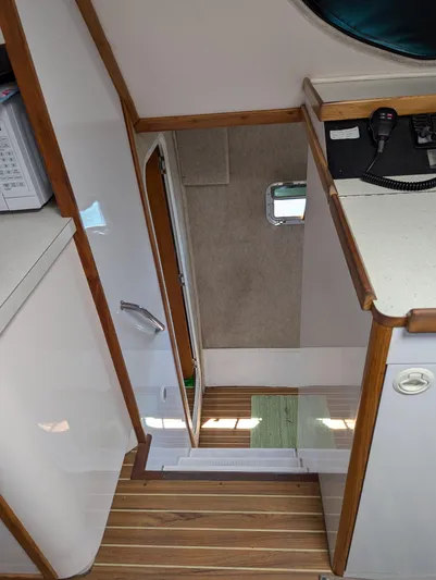  Yacht Photos Pics Interior view of 2000 Manta 42 boat, featuring wooden flooring and compact design.