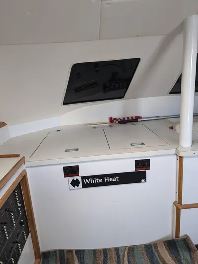  Yacht Photos Pics Interior of a 2000 Manta 42 boat, featuring storage compartments and a "White Heat" label.