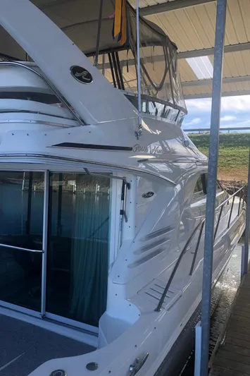 Callie B Yacht Photos Pics 2001 Sea Ray 400 Sedan Bridge yacht docked under a covered marina.