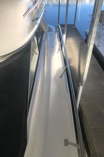 Callie B Yacht Photos Pics 2001 Sea Ray 400 Sedan Bridge yacht docked, side view with railing and water reflection.