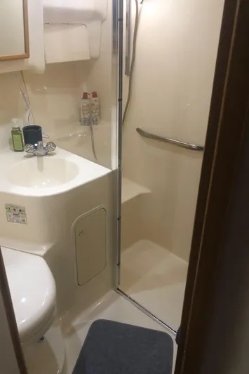 Callie B Yacht Photos Pics Bathroom interior of 2001 Sea Ray 400 Sedan Bridge yacht, featuring shower and sink.