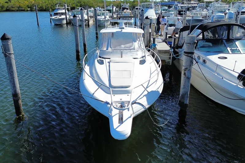  Yacht Photos Pics 2001 Intrepid 377 Walkaround boat docked at marina, surrounded by other vessels.