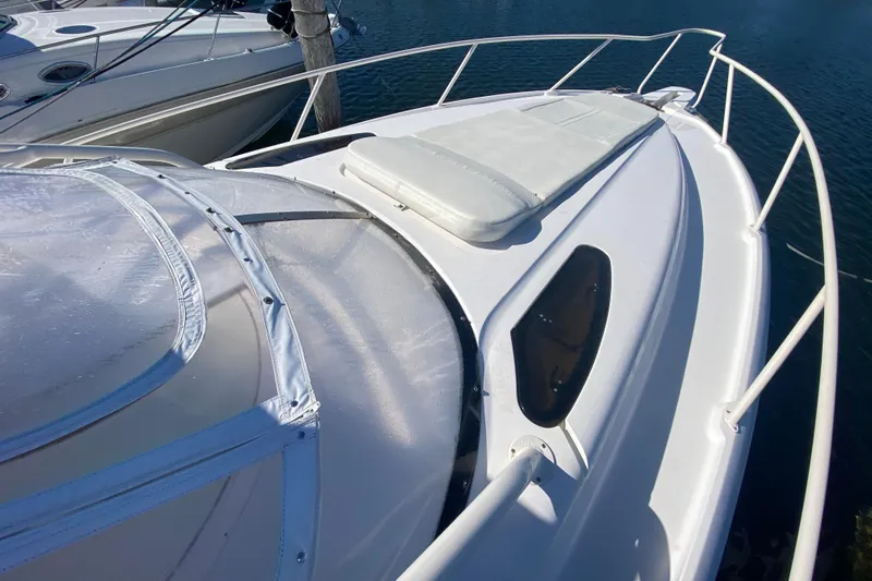  Yacht Photos Pics 2001 Intrepid 377 Walkaround boat deck with cushioned seating and railing.