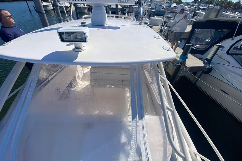  Yacht Photos Pics 2001 Intrepid 377 Walkaround boat docked at marina with people nearby.