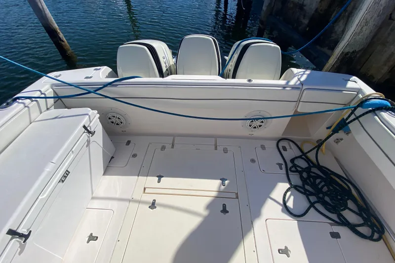  Yacht Photos Pics 2001 Intrepid 377 Walkaround boat deck with outboard motors and docked ropes.