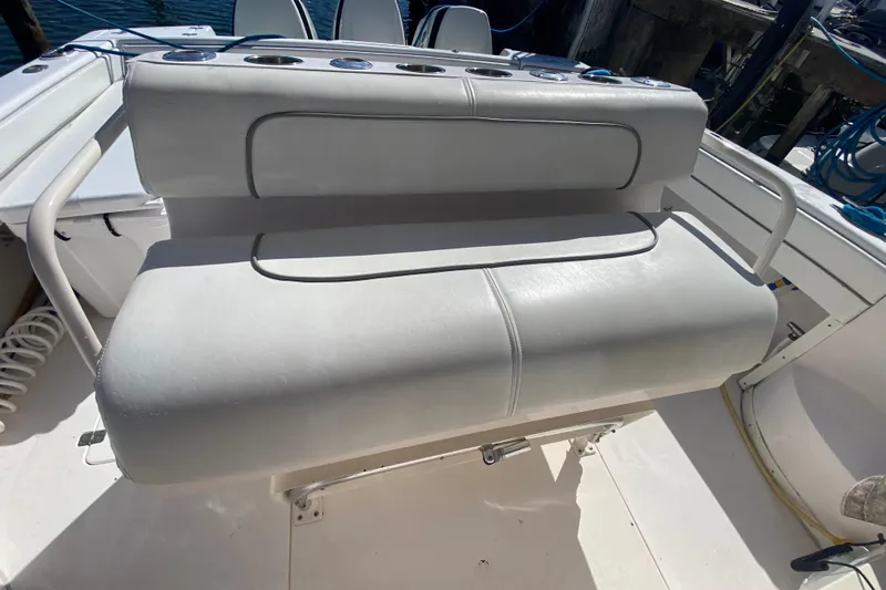  Yacht Photos Pics 2001 Intrepid 377 Walkaround boat seat with white upholstery and rod holders.
