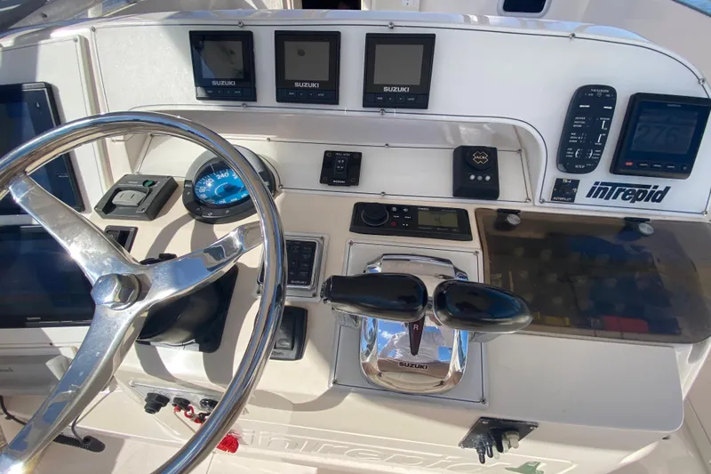  Yacht Photos Pics 2001 Intrepid 377 Walkaround boat dashboard with steering wheel and control panels.