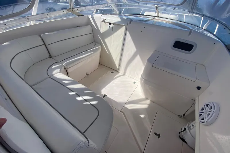  Yacht Photos Pics 2001 Intrepid 377 Walkaround interior with white seating and storage compartments.