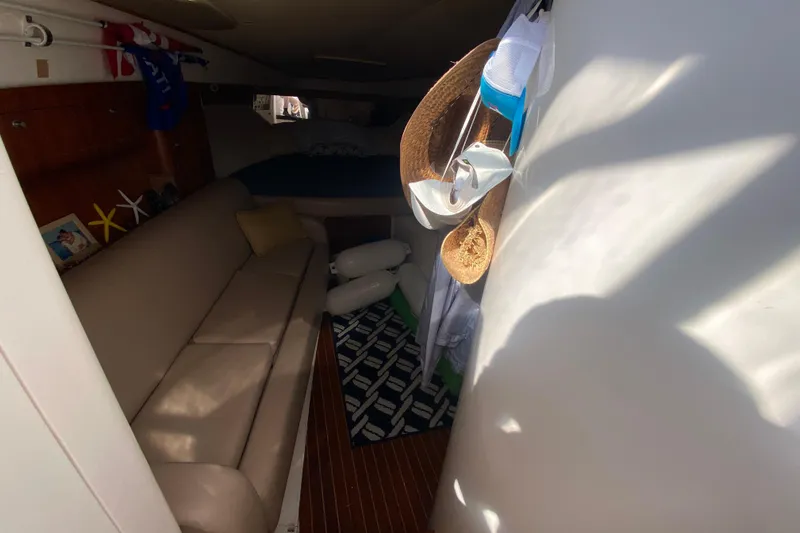  Yacht Photos Pics Interior of 2001 Intrepid 377 Walkaround boat with cozy seating and nautical decor.