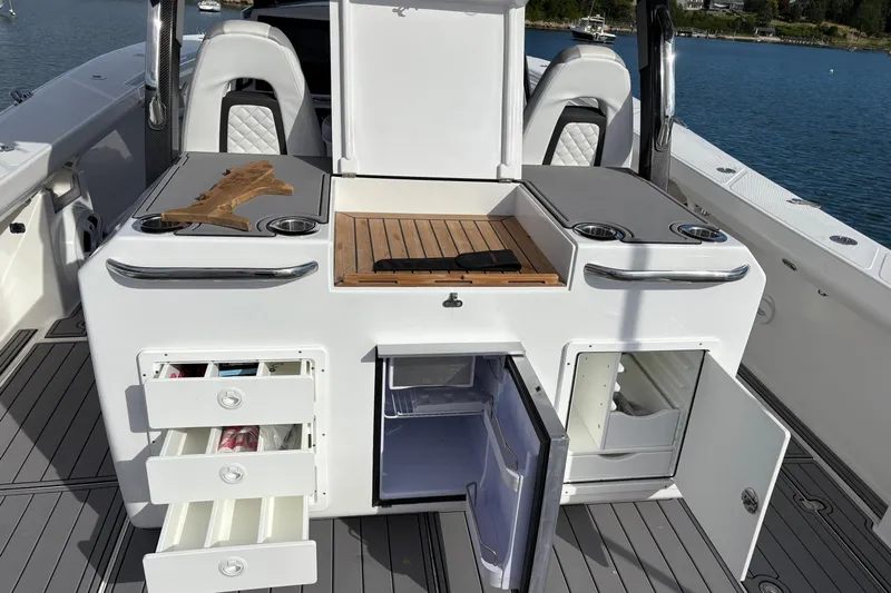 Hammercat 35-115 Yacht Photos Pics 2021 Hammer Yachts HammerCat 35 interior with open storage and seating, docked by the water.
