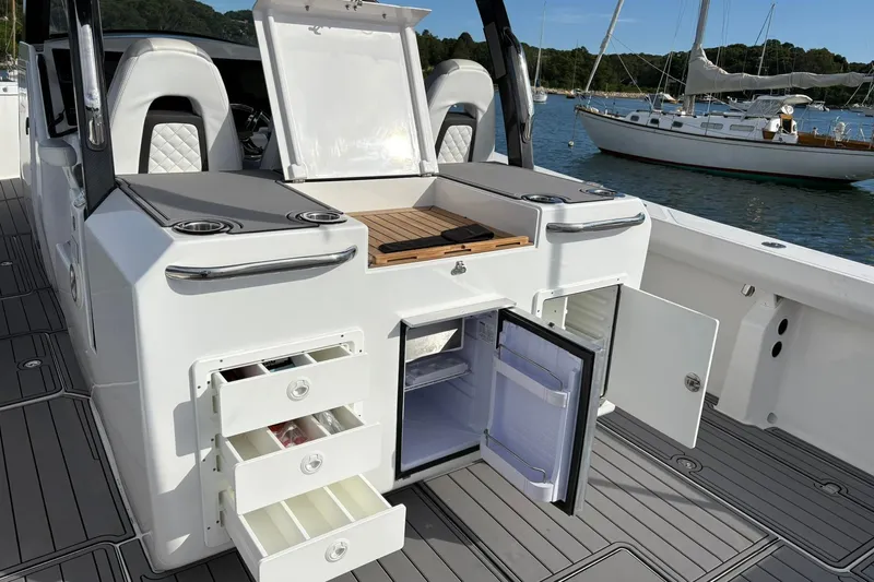 Hammercat 35-115 Yacht Photos Pics 2021 Hammer Yachts HammerCat 35 interior with open storage, drawers, and fridge on deck.