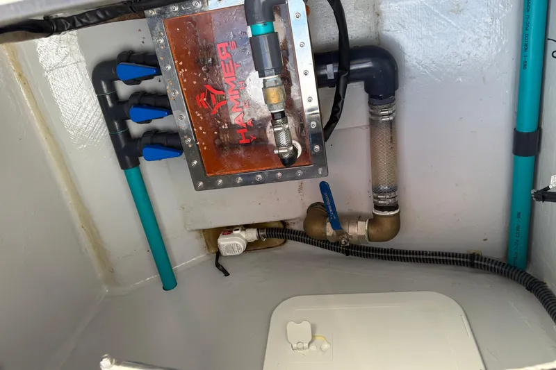 Hammercat 35-115 Yacht Photos Pics Engine compartment of 2021 Hammer Yachts HammerCat 35 with visible plumbing and components.
