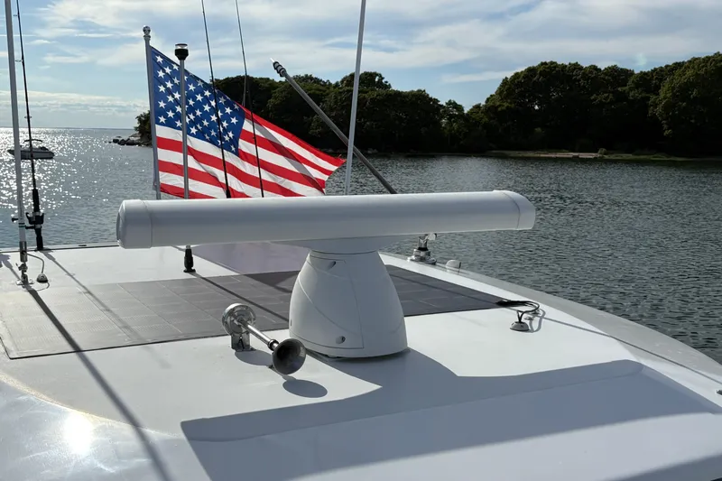 Hammercat 35-115 Yacht Photos Pics 2021 Hammer Yachts HammerCat 35 with American flag on calm waters.