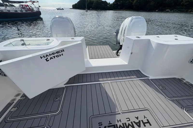 Hammercat 35-115 Yacht Photos Pics 2021 Hammer Yachts HammerCat 35 boat deck with twin engines on calm water.