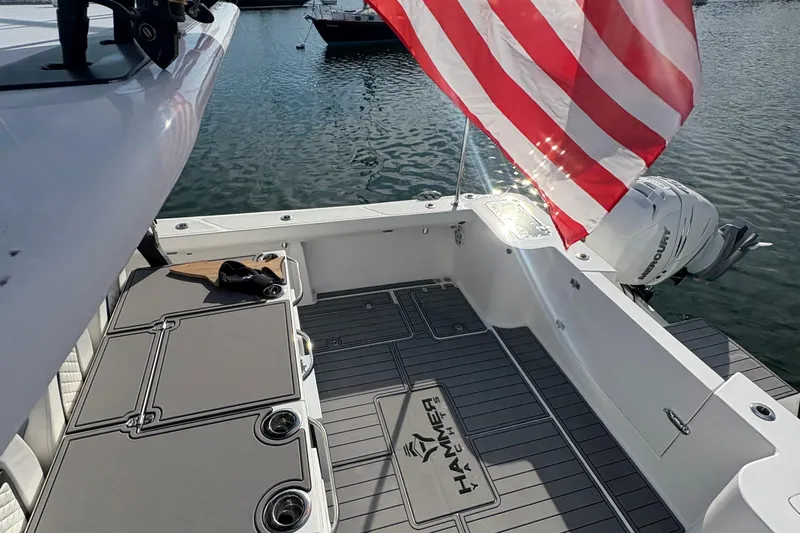 Hammercat 35-115 Yacht Photos Pics 2021 Hammer Yachts HammerCat 35 deck with American flag and Mercury outboard motor.