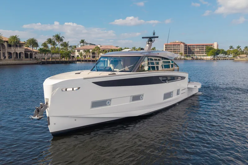  Yacht Photos Pics 2025 Azimut Seadeck 6 yacht cruising on a sunny waterfront.