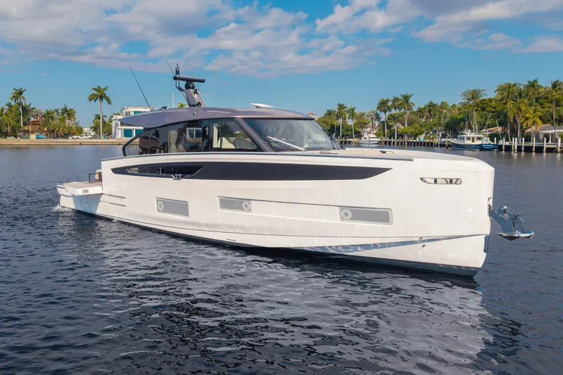  Yacht Photos Pics 2025 Azimut Seadeck 6 yacht cruising on a sunny day with palm trees in the background.