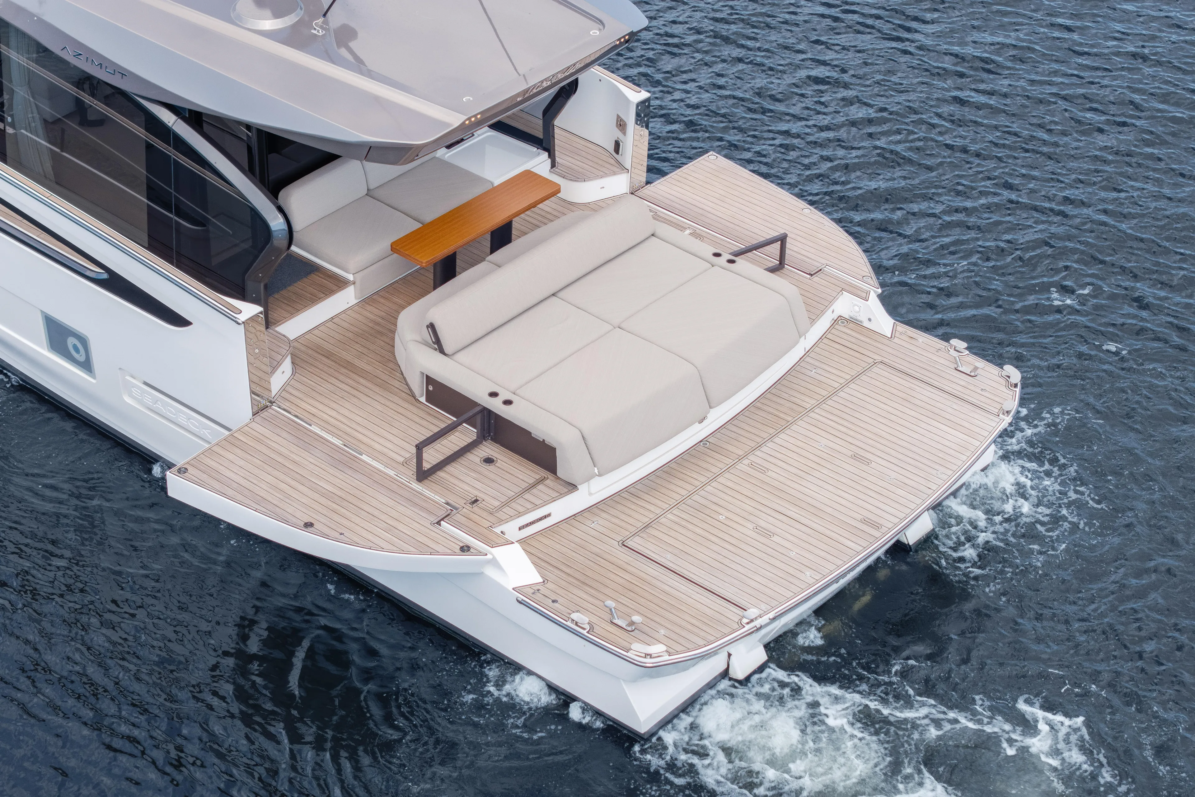  Yacht Photos Pics 2025 Azimut Seadeck 6 yacht with spacious deck and elegant seating on water.