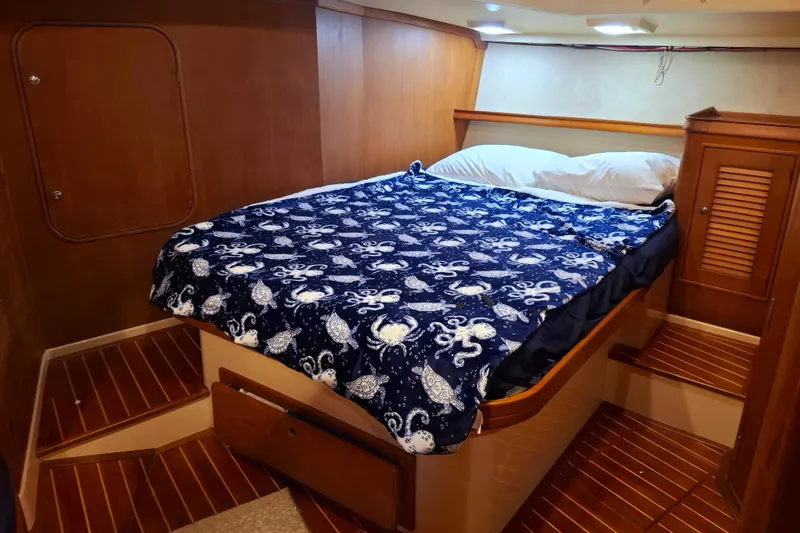 Priva Sea Yacht Photos Pics Cozy cabin interior of 2003 Island Packet 485 with nautical-themed bedding.