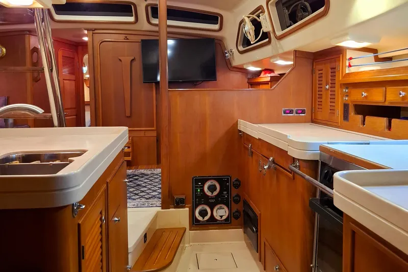 Priva Sea Yacht Photos Pics Interior of 2003 Island Packet 485 yacht, featuring a well-equipped galley and wooden cabinetry.