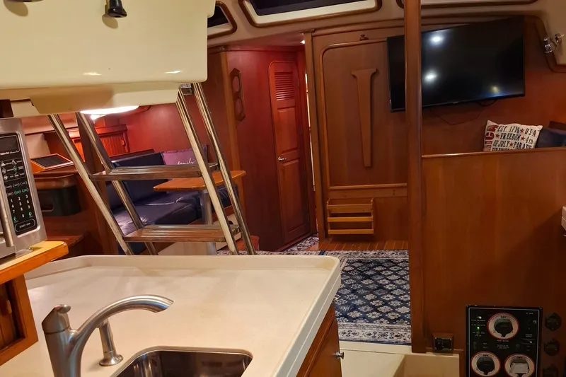 Priva Sea Yacht Photos Pics Interior of 2003 Island Packet 485 yacht with kitchen, seating, and TV.