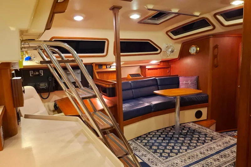 Priva Sea Yacht Photos Pics Luxurious interior of 2003 Island Packet 485 yacht with blue seating and wooden accents.