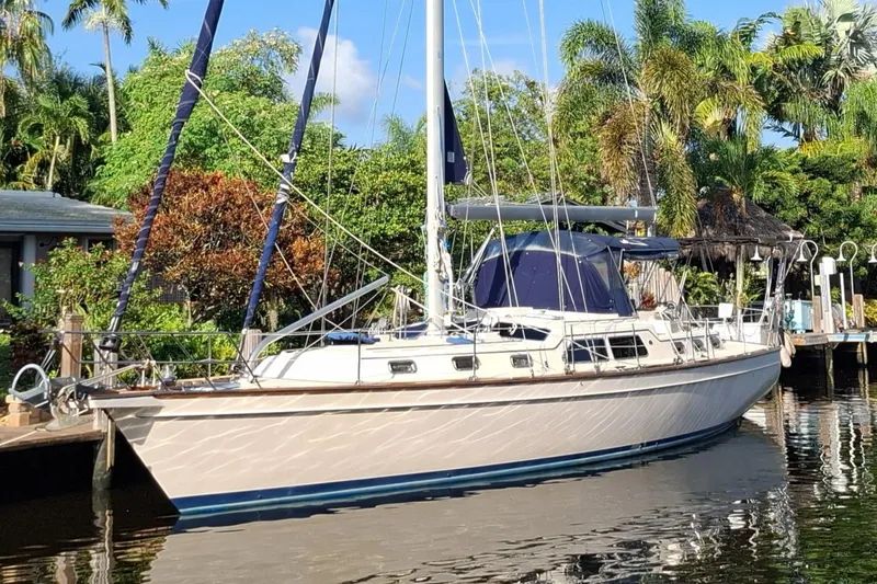 Priva Sea Yacht Photos Pics 2003 Island Packet 485 sailboat docked by lush tropical greenery.