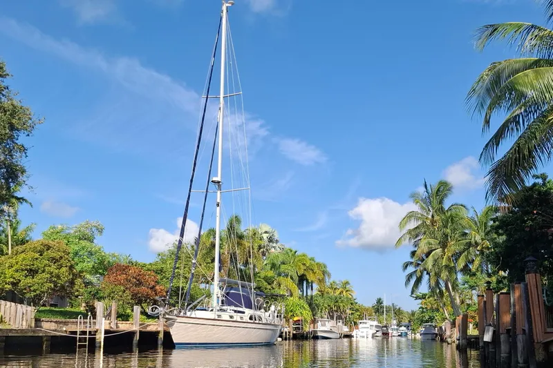 Priva Sea Yacht Photos Pics Sailboat Island Packet 485, 2003 model, docked in a tropical canal with palm trees.