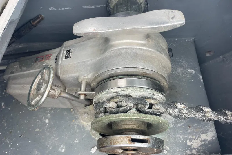 Futuna Yacht Photos Pics Windlass mechanism on a 2004 Lagoon 570 yacht, featuring a chain and manual handle.