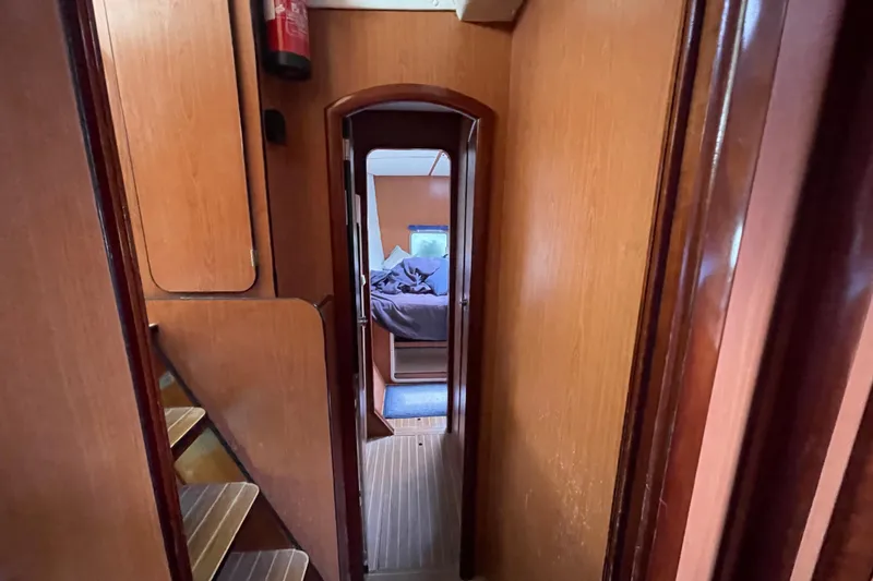 Futuna Yacht Photos Pics Interior view of 2004 Lagoon 570 yacht, featuring wooden hallway and cozy cabin.