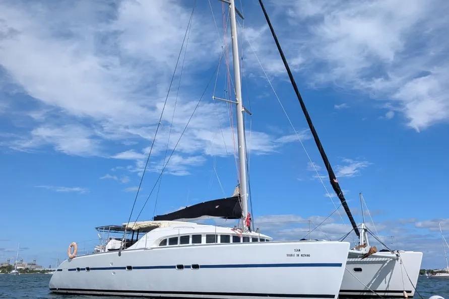 2004 Lagoon 570 catamaran sailing on a clear day with blue skies.