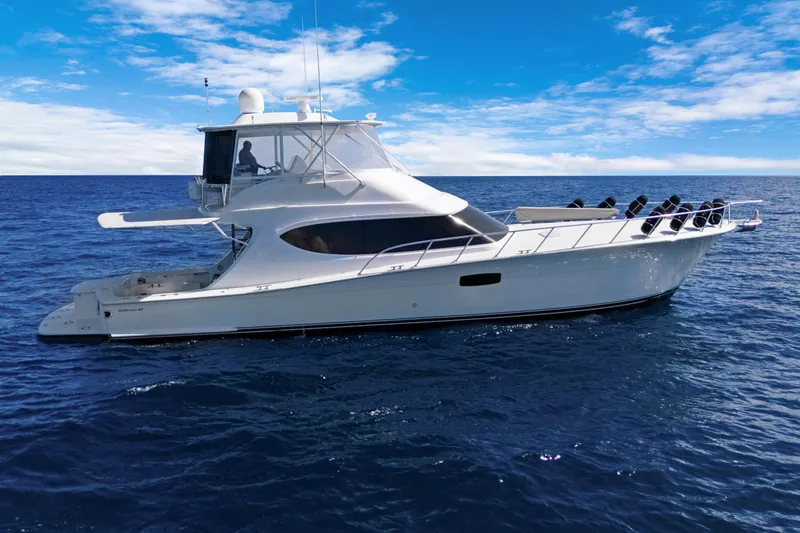  Yacht Photos Pics 2016 Hatteras 63GT yacht cruising on open ocean under clear blue sky.