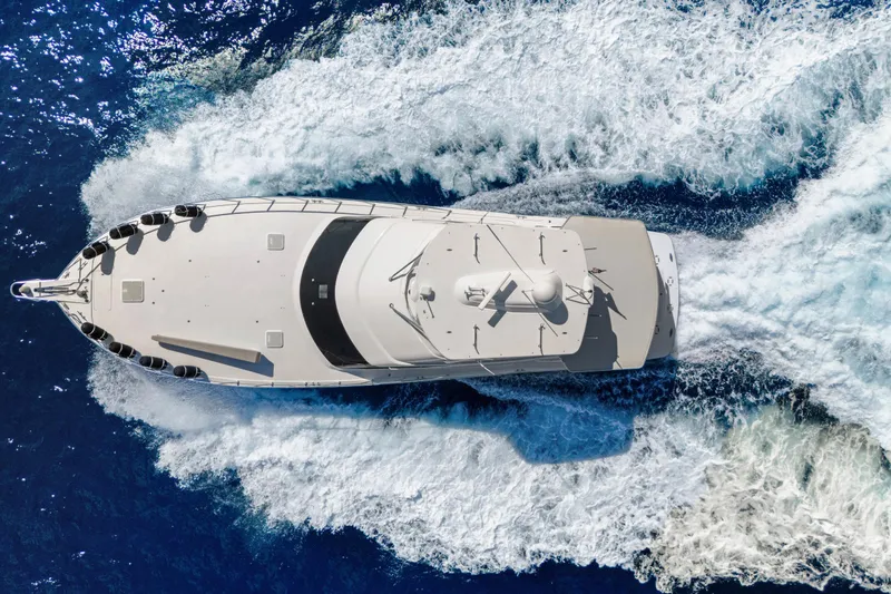  Yacht Photos Pics Aerial view of 2016 Hatteras 63GT yacht cruising through blue ocean waters.