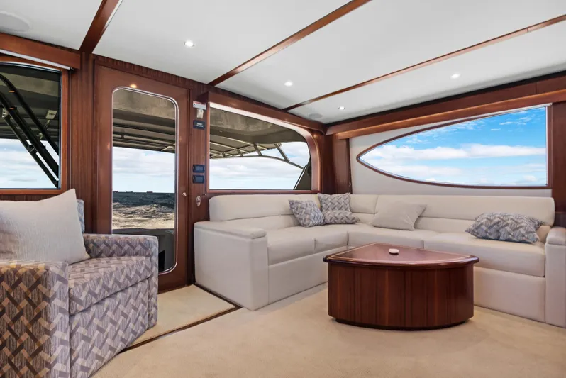 Yacht Photos Pics Luxurious interior of 2016 Hatteras 63GT yacht with plush seating and elegant wood finishes.