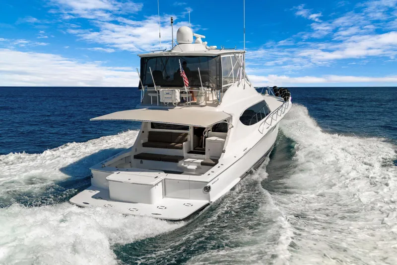  Yacht Photos Pics 2016 Hatteras 63GT yacht cruising on open sea under clear blue sky.