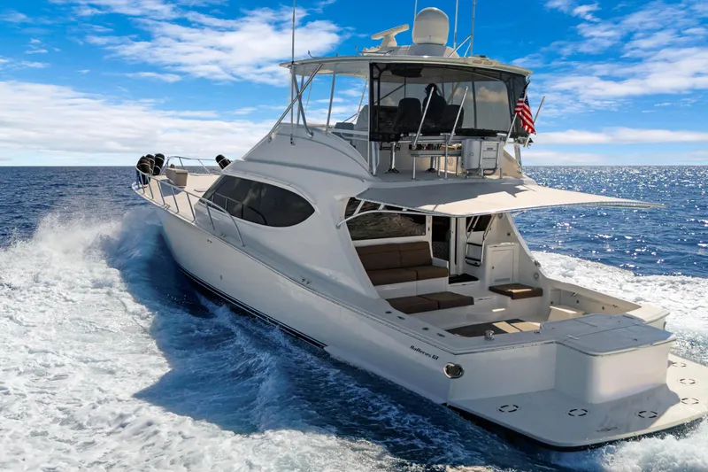  Yacht Photos Pics 2016 Hatteras 63GT yacht cruising on open ocean under clear blue sky.