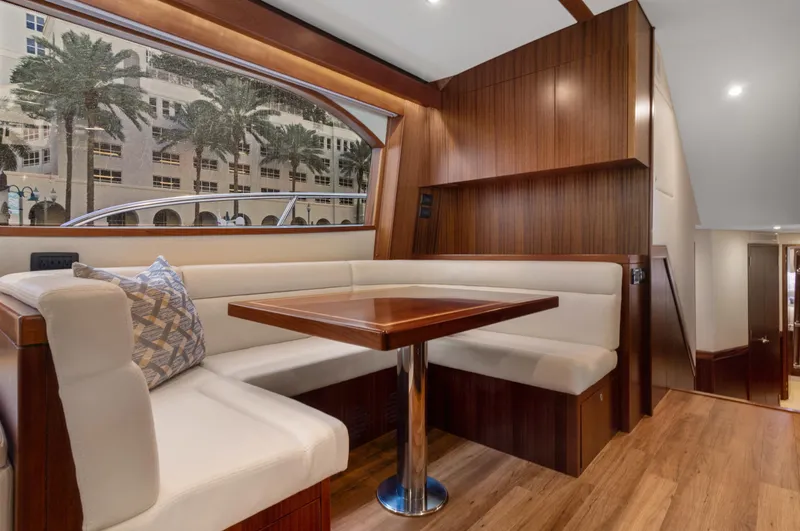  Yacht Photos Pics Luxurious interior of 2016 Hatteras 63GT yacht with elegant wood finishes and plush seating.