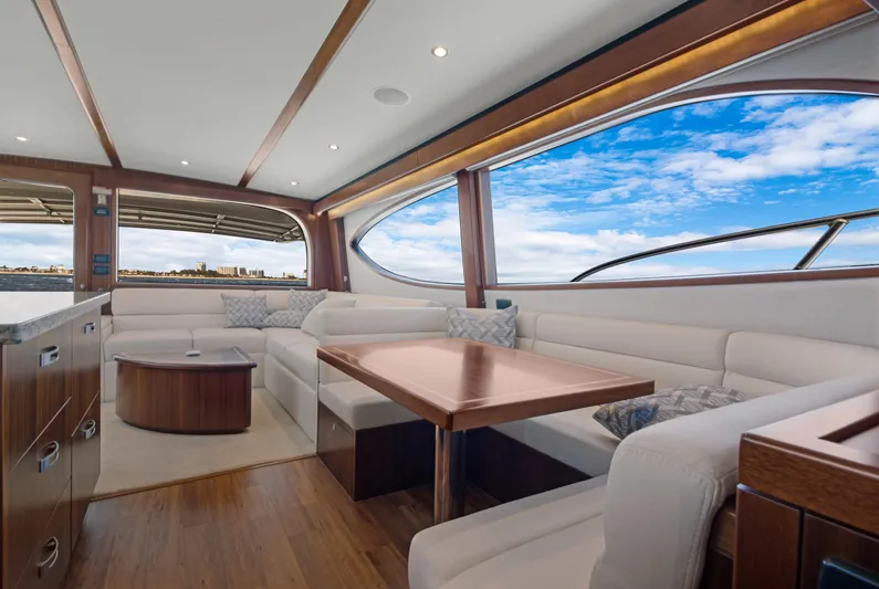  Yacht Photos Pics Luxurious interior of 2016 Hatteras 63GT yacht with elegant seating and ocean view.