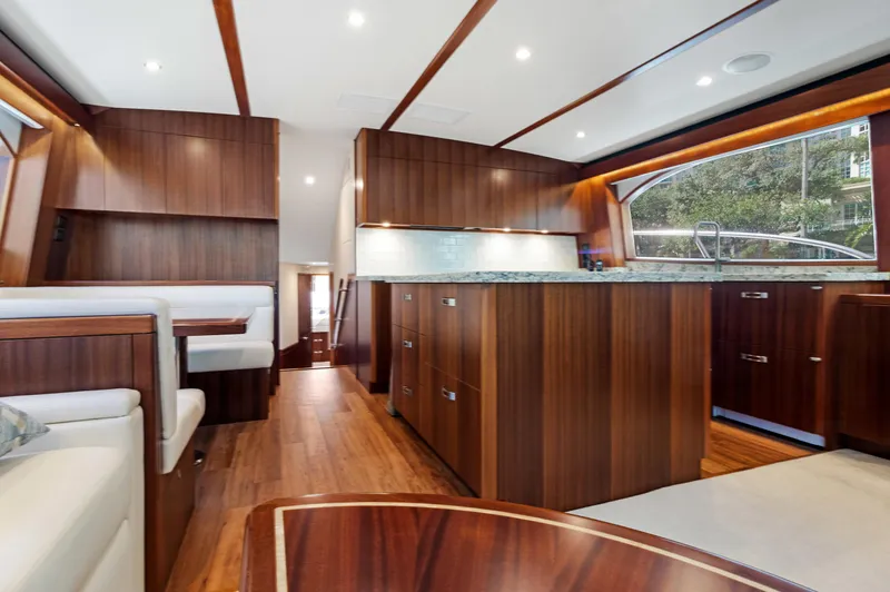  Yacht Photos Pics Luxurious interior of 2016 Hatteras 63GT yacht with elegant wood finishes and modern design.