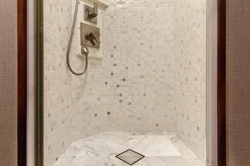  Yacht Photos Pics Luxurious shower with mosaic tiles in 2016 Hatteras 63GT yacht.