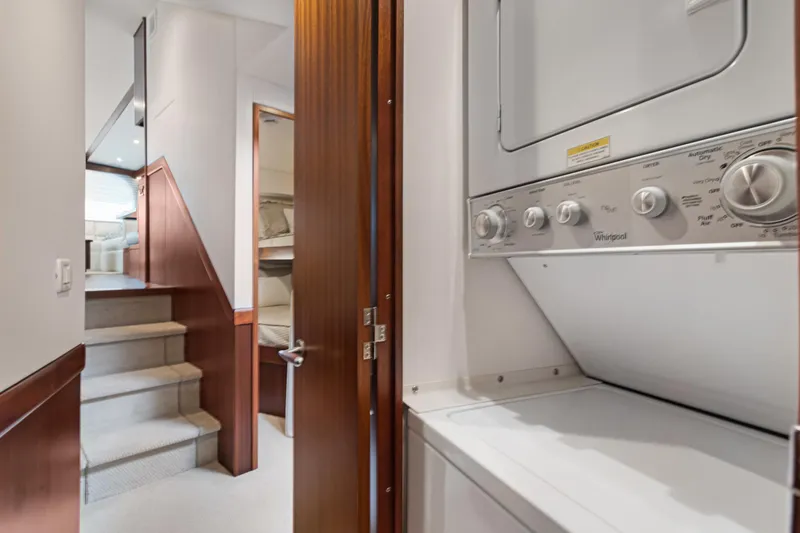  Yacht Photos Pics Laundry area inside 2016 Hatteras 63GT yacht with stacked washer and dryer.
