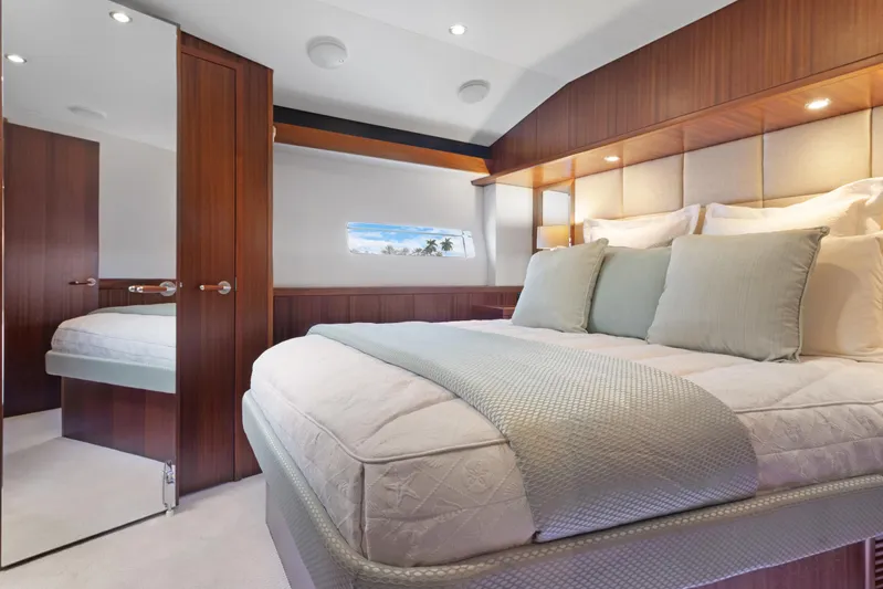  Yacht Photos Pics Luxurious bedroom interior of 2016 Hatteras 63GT yacht with elegant wood finishes.