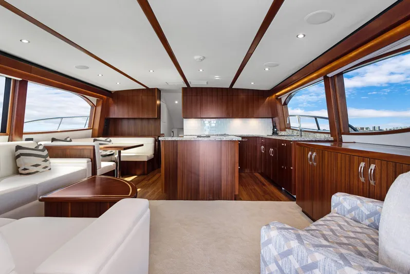  Yacht Photos Pics Luxurious interior of 2016 Hatteras 63GT yacht with elegant wood finishes and modern furnishings.