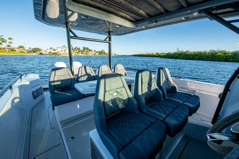 Chye-lukh Yacht Photos Pics 2021 Axopar 37 boat interior with luxurious seating on a scenic waterway.